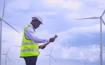 Engineer with wind turbines Infinity Power acquisition