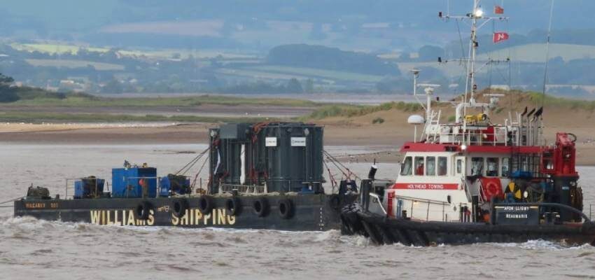 Tug boats accompany 178 T transformer as it passes Burnham-on-Sea