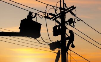 electricians on a pole_shutterstock_2425315767