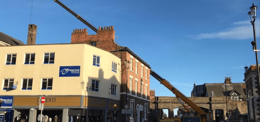 Giant crane replacing substation equipment substation